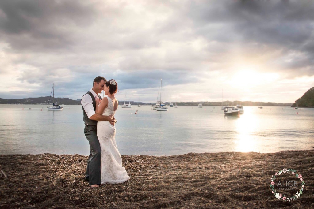 the Bride & Groom at sunset on Russell Beach NZ, hair Laurel Stratford Hairstylist 