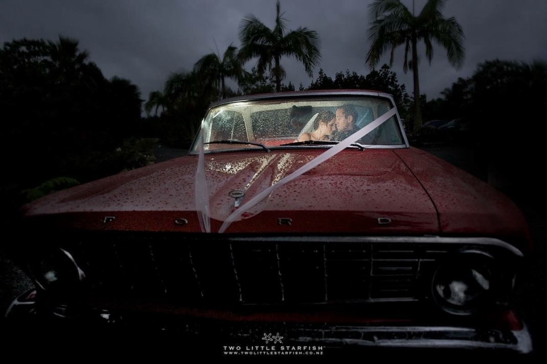 Bride & Groom in the car, in rain, Kerikeri, NZ. Hair Laurel Stratford