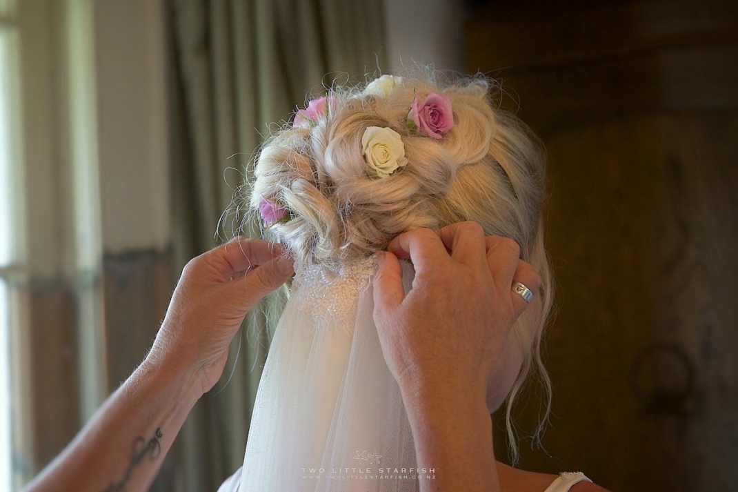 Back view of bridal hairstyle as veil being added