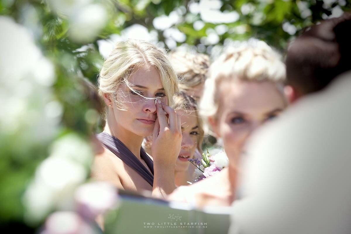 Bride's sister having a moment during wedding ceremony