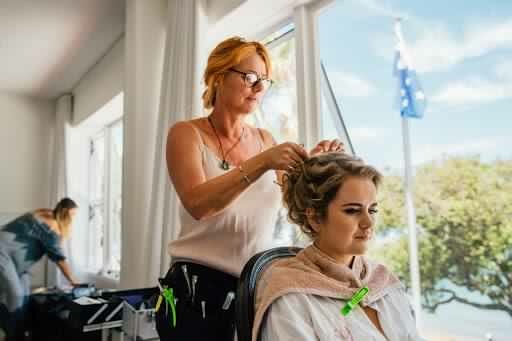 Bride having hair put up by Laurel stratford wedding hairstylist 