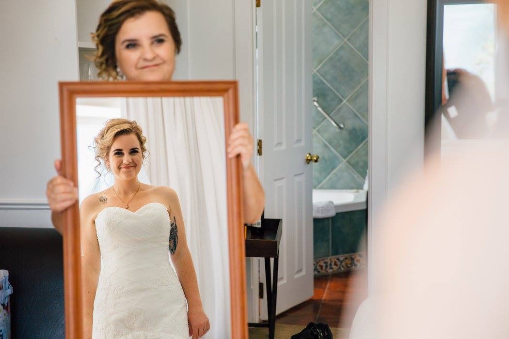 Mother of the Bride holding mirror for the bride. Hair Laurel Stratford wedding hairstylist 